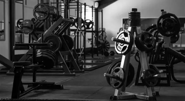 Máquinas de gimnasio con pesas y barras en un gimnasio.